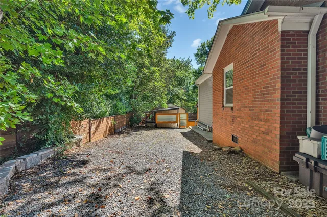 a backyard of a house with a tree