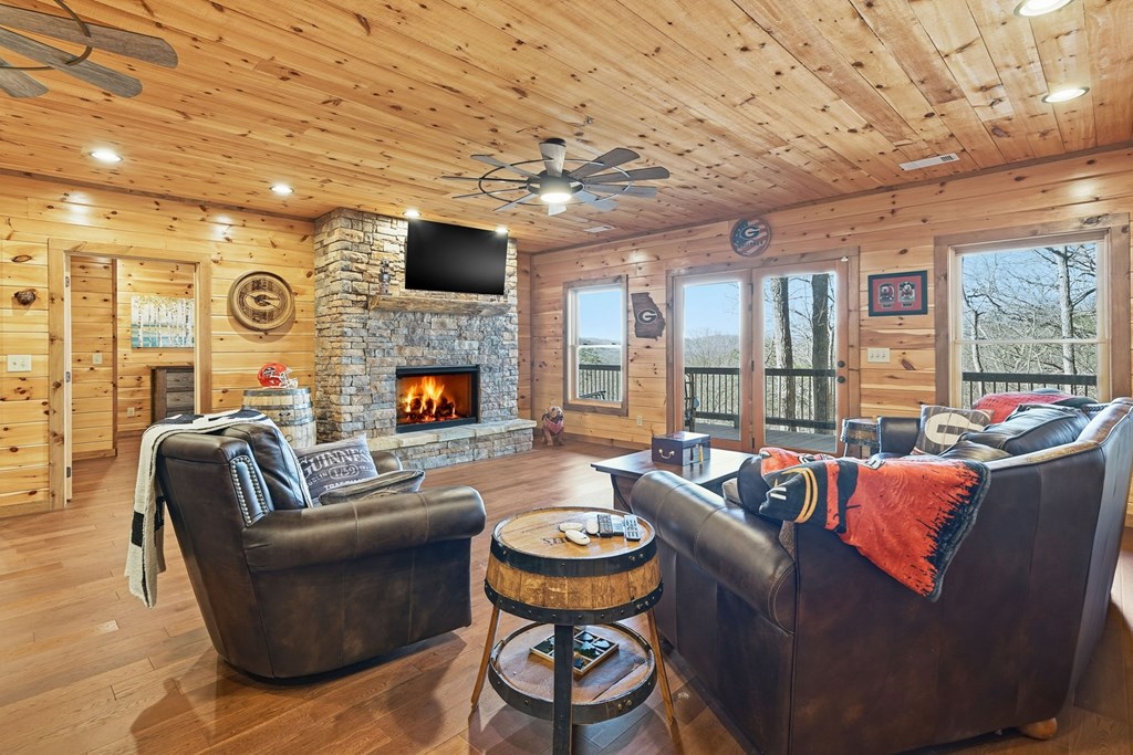 175 Stuart Drive Mineral Bluff, GA 30559 - Photo 26 of 45 a living room with fireplace furniture and a large window