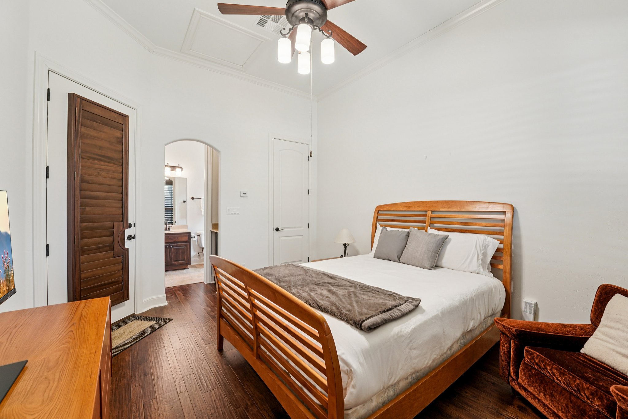 11613 Shadestone Terrace Austin, TX 78732 - Photo 11 of 35 a bedroom with a bed and wooden floor