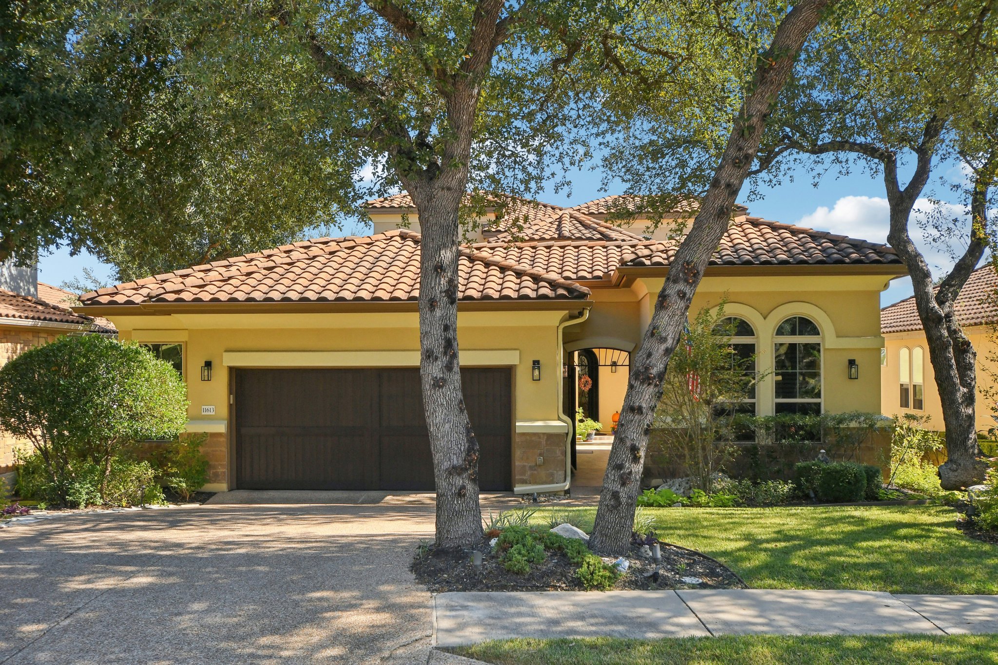11613 Shadestone Terrace Austin, TX 78732 - Photo 2 of 35 a front view of a house with garden