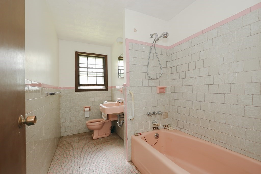 27 Trinity Street Danvers, MA 01923 - Photo 16 of 19 a bathroom with a bathtub a toilet and a shower