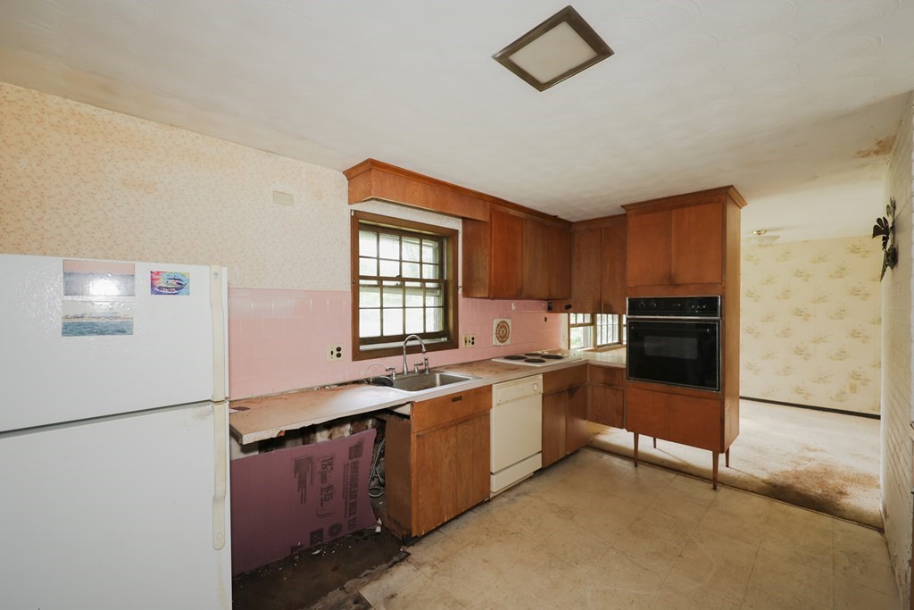 27 Trinity Street Danvers, MA 01923 - Photo 9 of 19 a kitchen with stainless steel appliances granite countertop a stove a refrigerator and a refrigerator