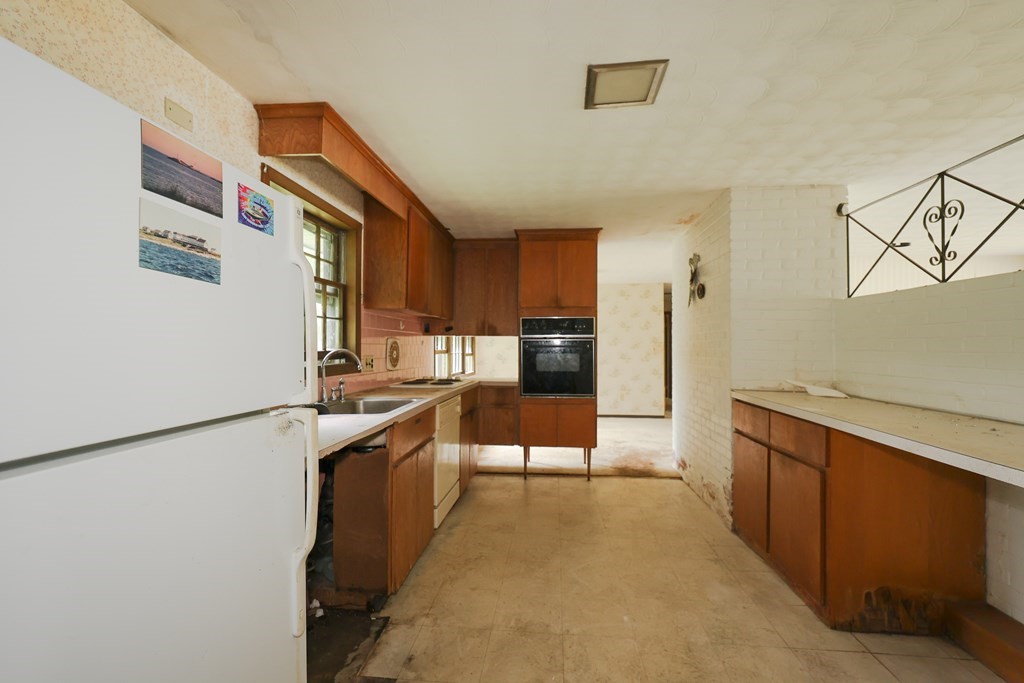 27 Trinity Street Danvers, MA 01923 - Photo 10 of 19 a kitchen with stainless steel appliances granite countertop a refrigerator and a stove top oven