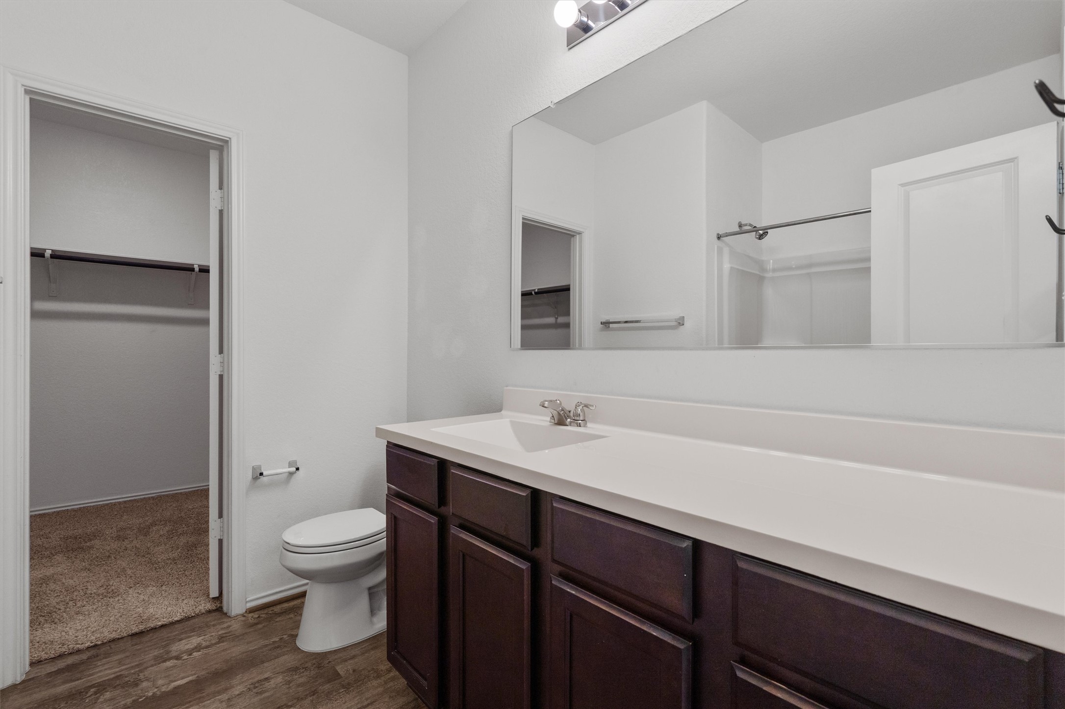 791 Circle Way Jarrell, TX 76537 - Photo 18 of 36 Bathroom vanity featuring a single sink with chrome faucet, a white countertop, and dark wood-finish cabinetry