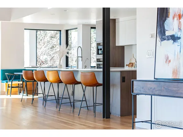 a dining room with wooden floor glass table and chairs