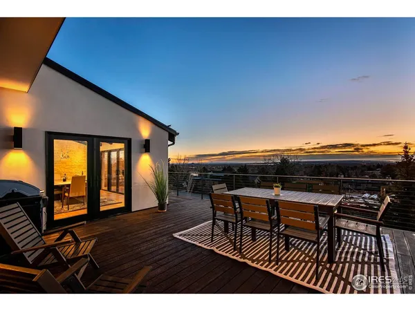 a dining room with furniture and a large window