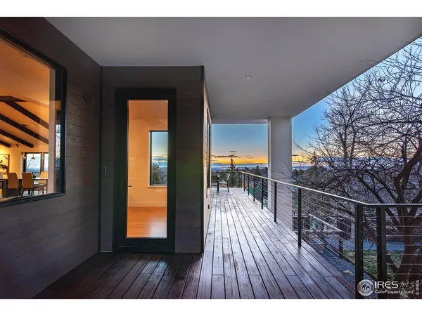 a kitchen with a table chairs in it and wooden floors