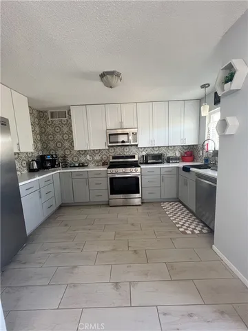 a kitchen with a sink a stove and cabinets