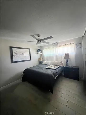 a bedroom with a bed and a mirror