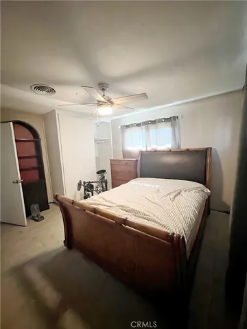 a bedroom with a bed and a mirror