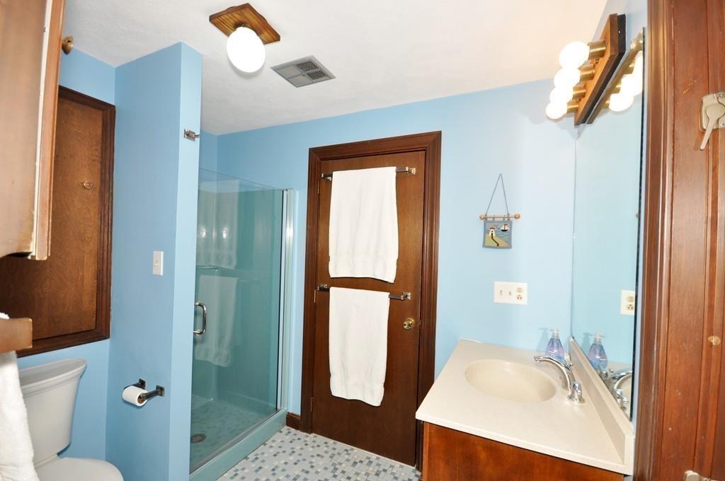 17 Cox Road Winchester, MA 01890 - Photo 12 of 19 a bathroom with a sink a toilet and shower