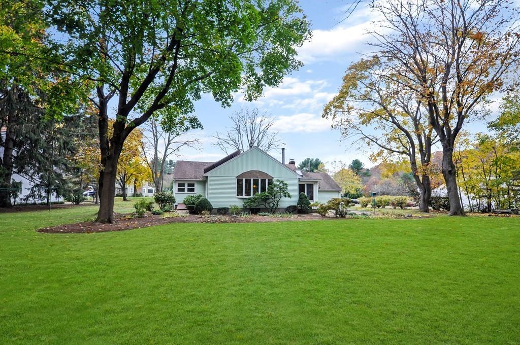 17 Cox Road Winchester, MA 01890 - Photo 15 of 19 a large house with a big yard and large trees