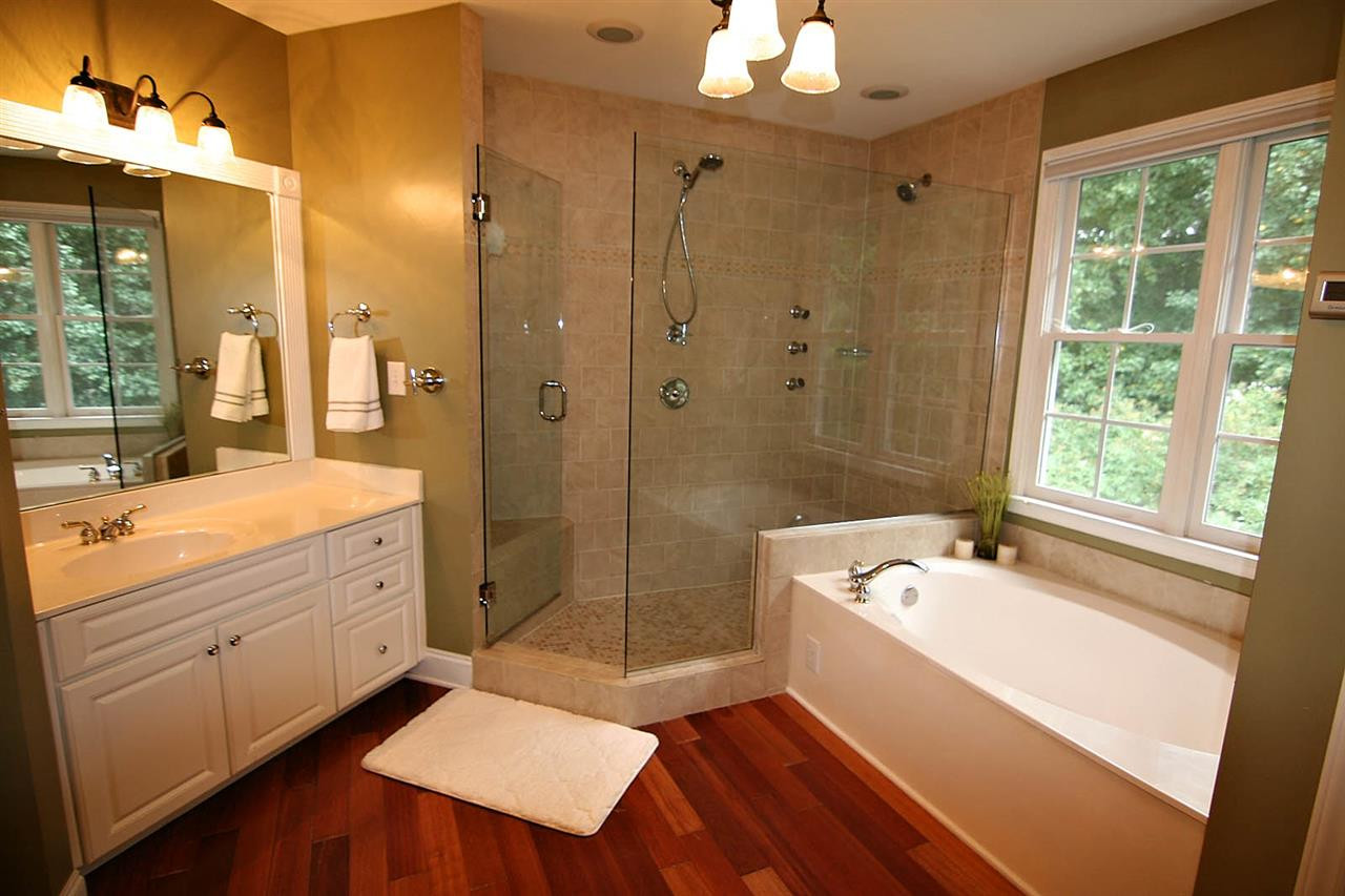 4109 Batiste Road Raleigh, NC 27613 - Photo 16 of 25 Master Bathroom has Dual Vanities, and a LUXURY Shower with a Bench and Three Zones including Dual Shower Heads, and Body Sprays and a soaking tub. Master Bathroom