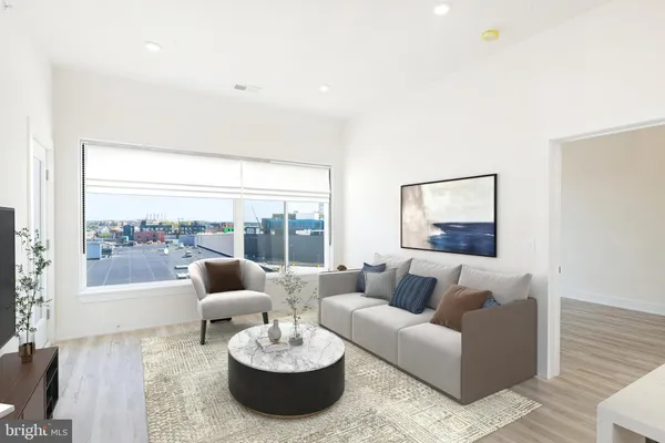 a living room with furniture and a large window