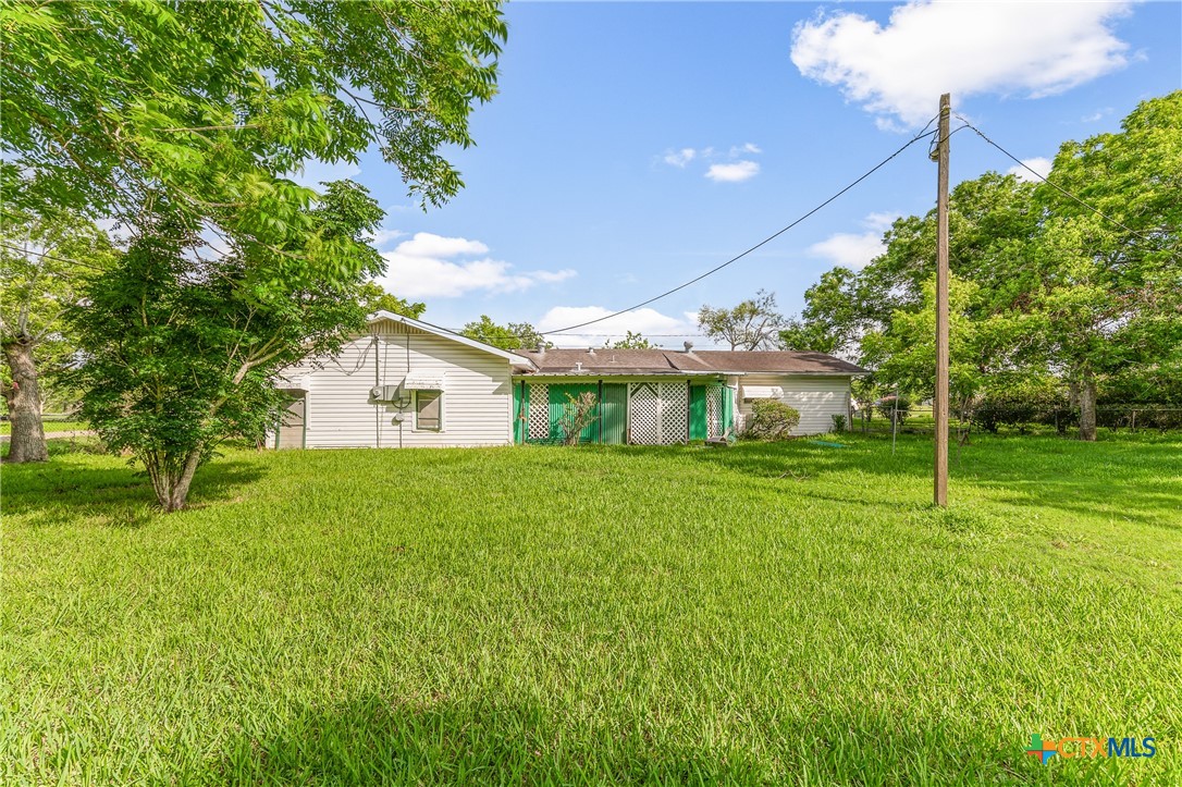 401 Kerr Street Edna, TX 77957 - Photo 20 of 23 a front view of house with yard and green space
