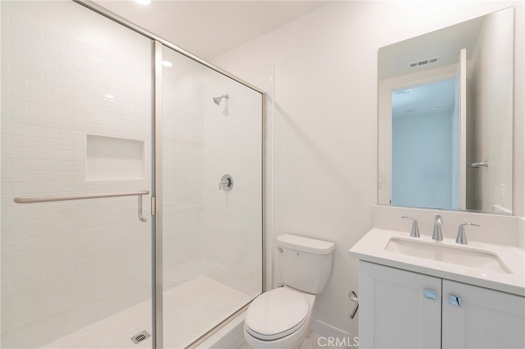 121 Baluster Irvine, CA 92618 - Photo 36 of 80 a bathroom with a granite countertop sink toilet and shower