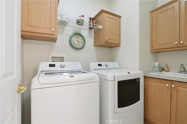 a view of a storage and utility room with washer and dryer
