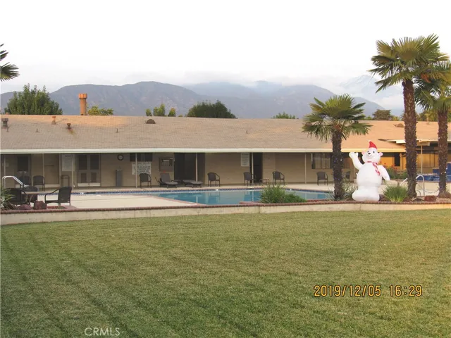 a view of house with outdoor space and swimming pool