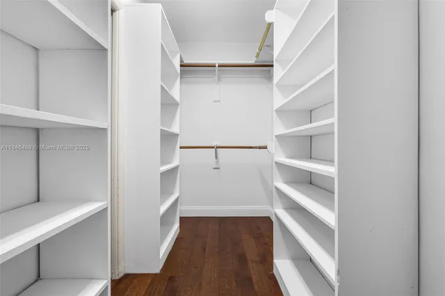 a view of walk in closet with empty racks