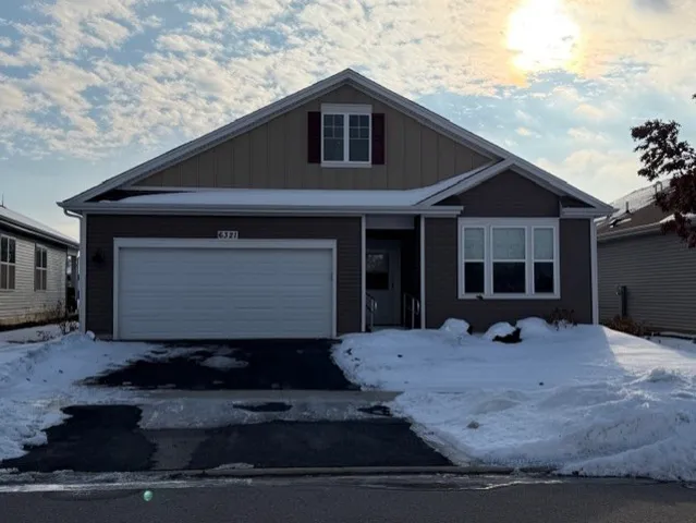 a front view of a house with garage