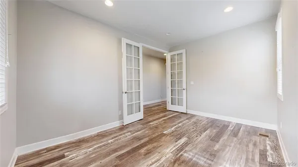 an empty room with wooden floor and closet