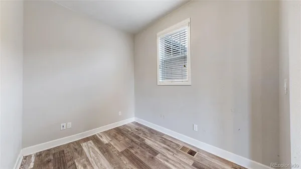 a view of room with window and hardwood floor