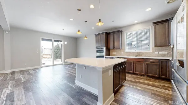 a large kitchen with stainless steel appliances granite countertop a sink and a stove