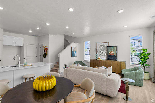 3074 South 270 West Logan, UT 84321 - Photo 2 of 30 Open-concept living area with light-toned wood-finish flooring, recessed lighting, and white walls