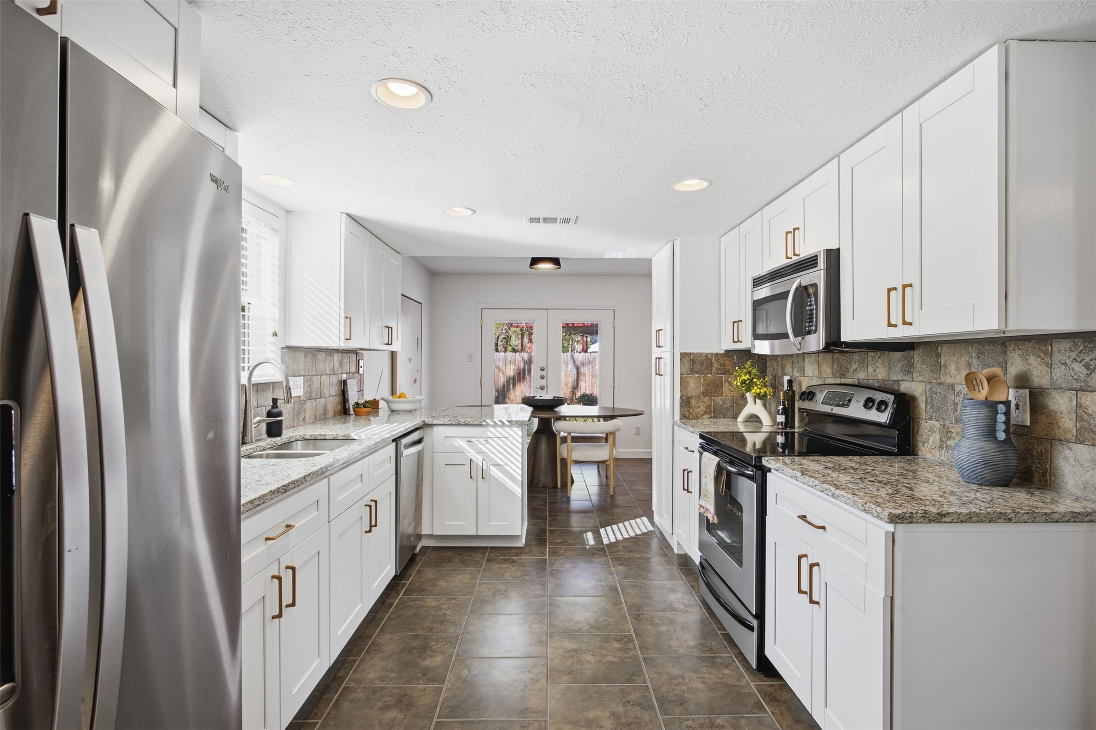 3200 Spaniel Drive Austin, TX 78759 - Photo 13 of 24 a kitchen with white cabinets and appliances