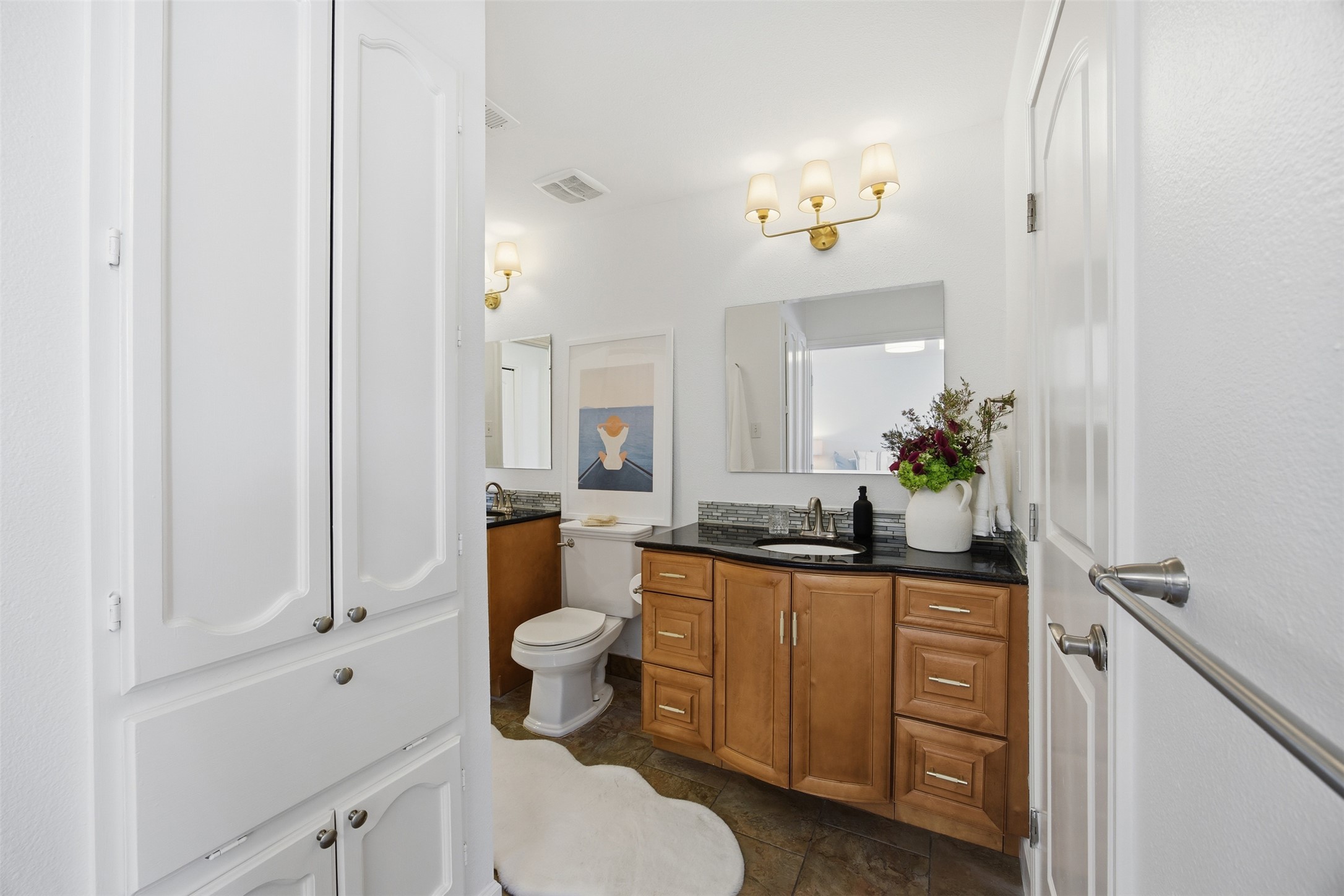 3200 Spaniel Drive Austin, TX 78759 - Photo 18 of 24 a bathroom with a granite countertop sink a toilet and mirror