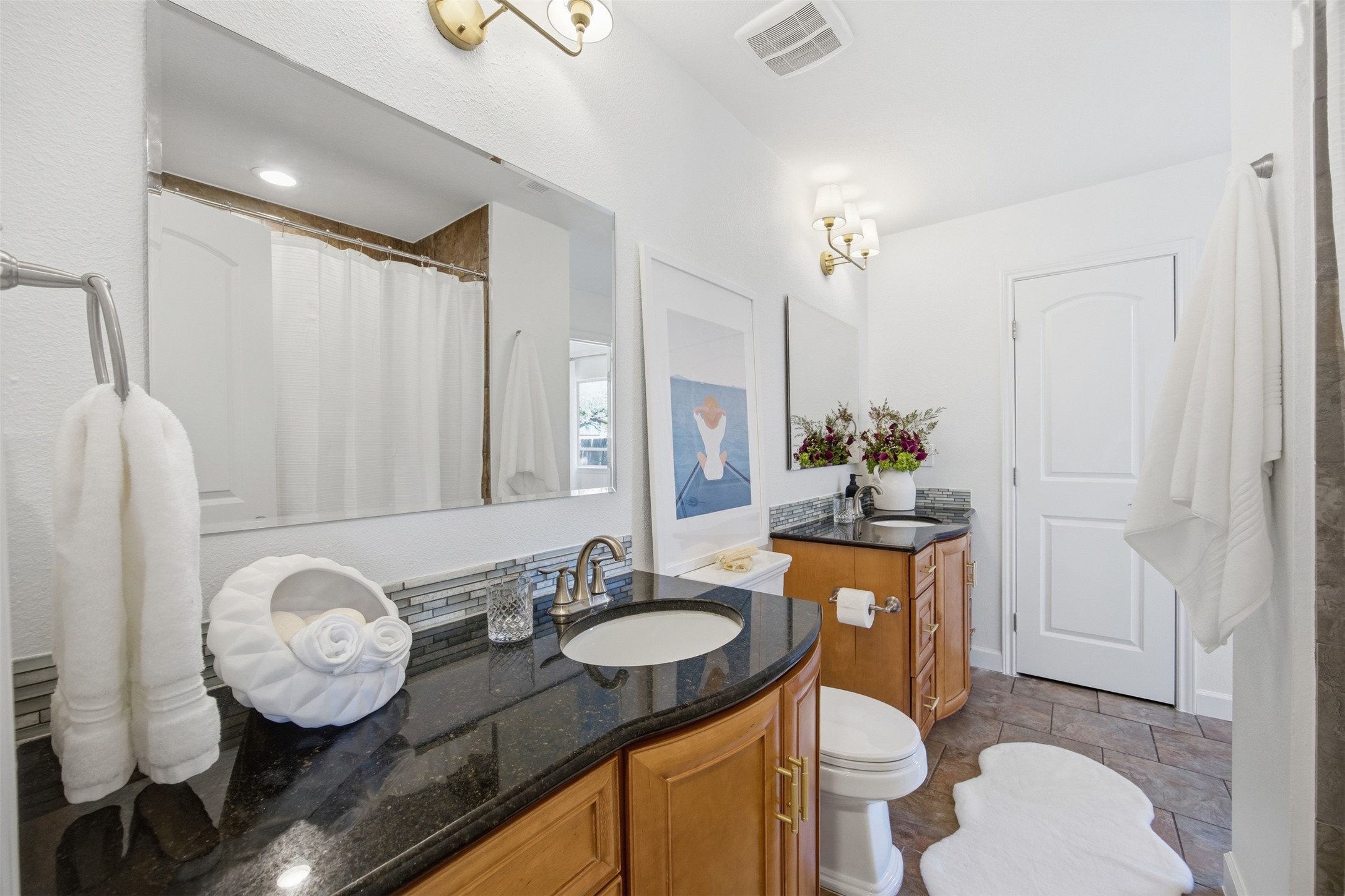 3200 Spaniel Drive Austin, TX 78759 - Photo 19 of 24 a bathroom with a granite countertop sink a toilet a mirror and shower