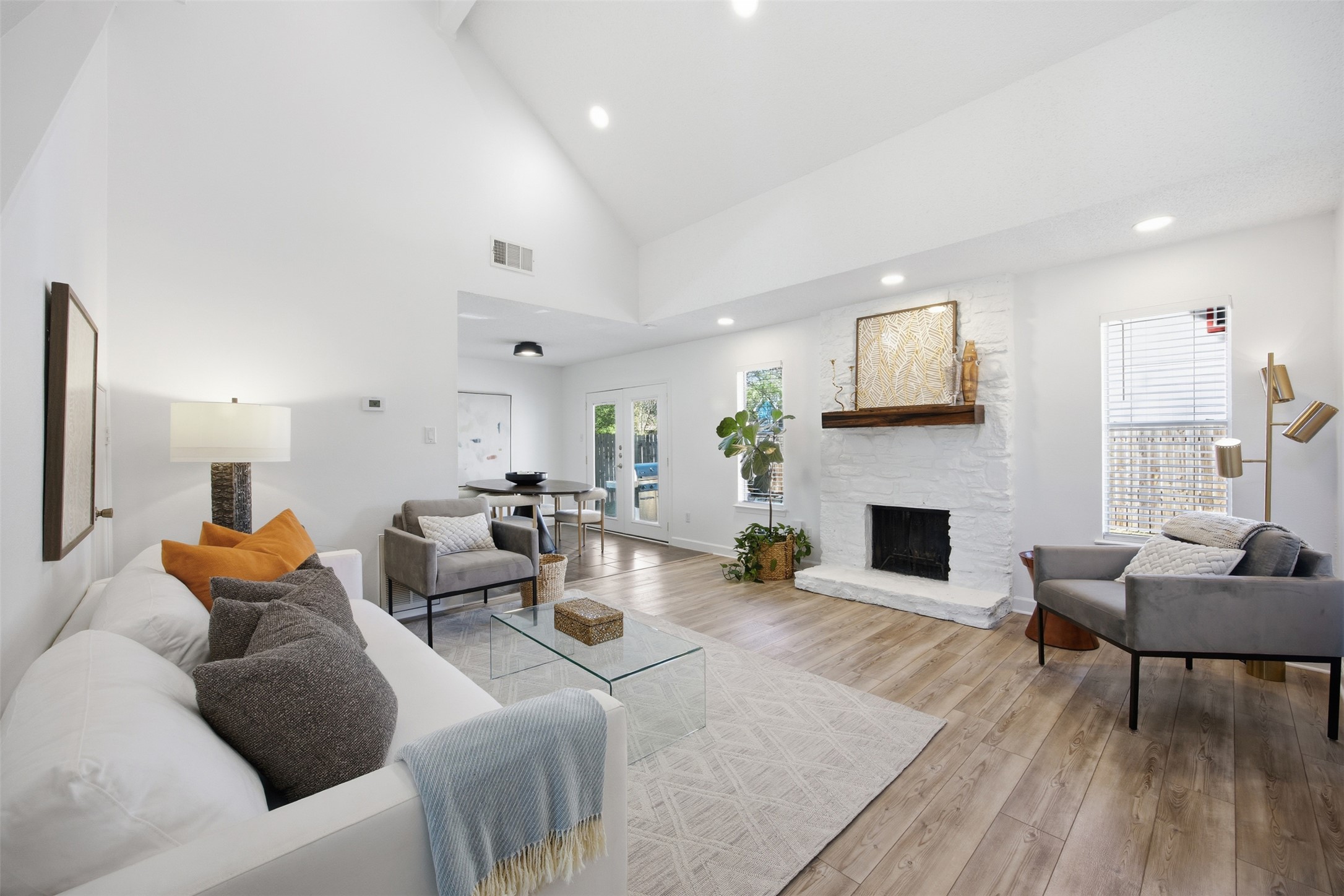 3200 Spaniel Drive Austin, TX 78759 - Photo 2 of 24 a living room with furniture a fireplace and a large window