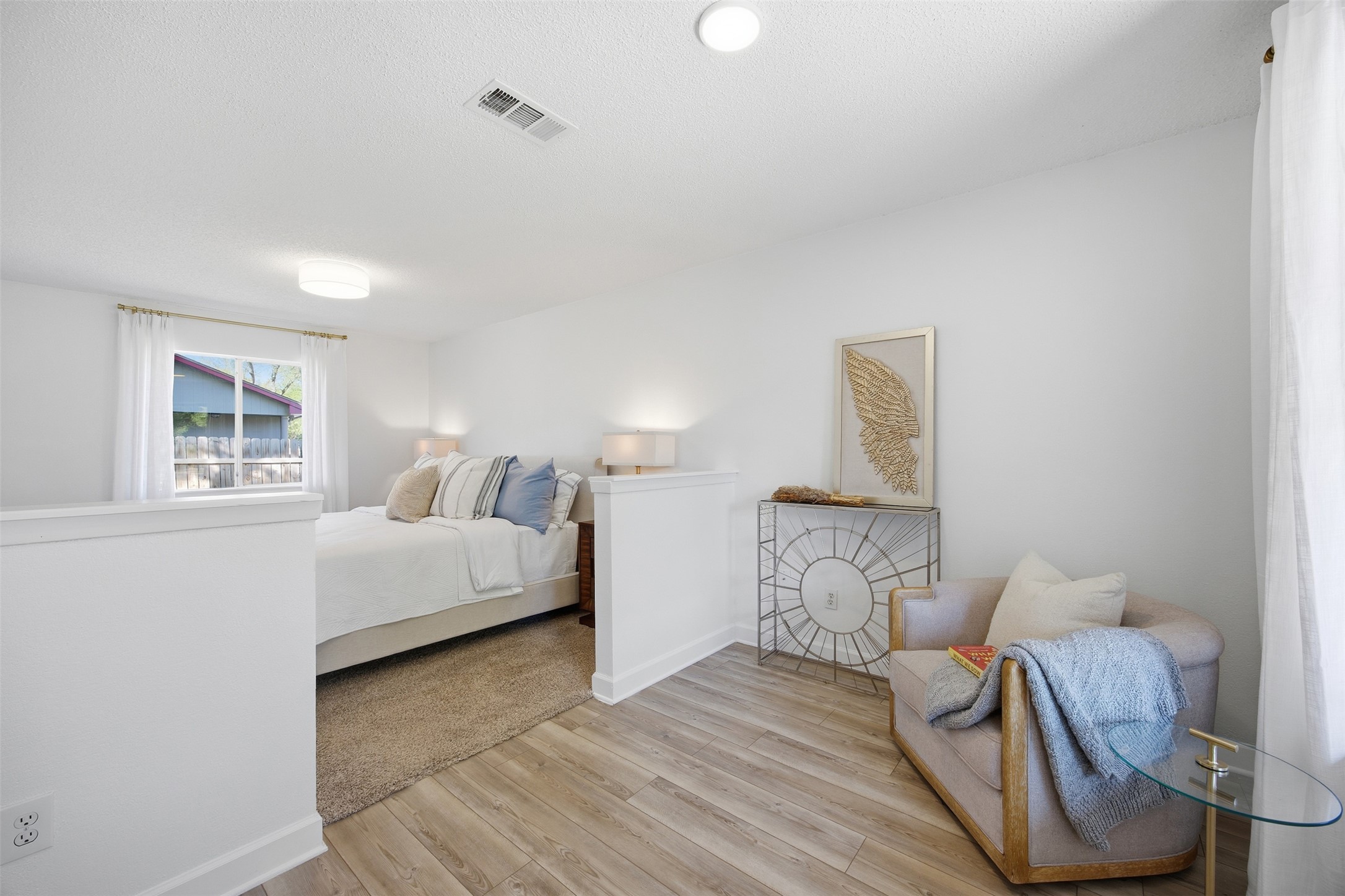 3200 Spaniel Drive Austin, TX 78759 - Photo 3 of 24 a bedroom with a bed and wooden floor