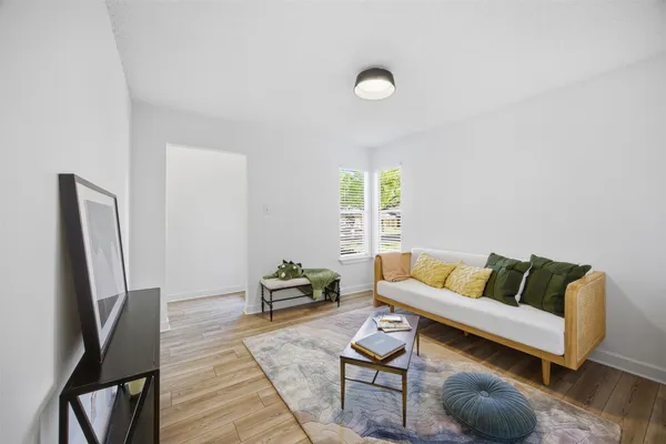 a living room with furniture rug and a window