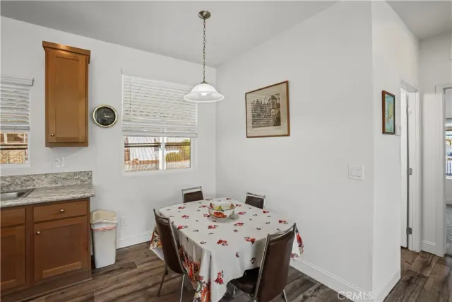 a kitchen a sink refrigerator and microwave
