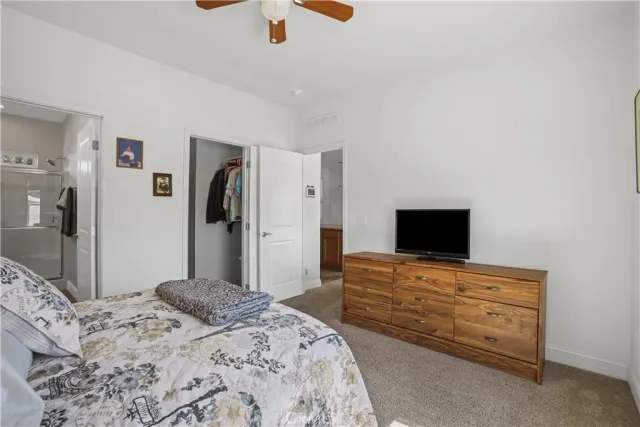 a bedroom with a bed and a television