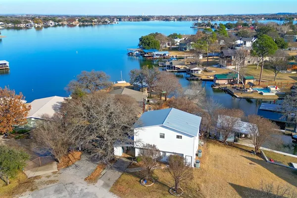 a view of a lake with boats and trees in the background