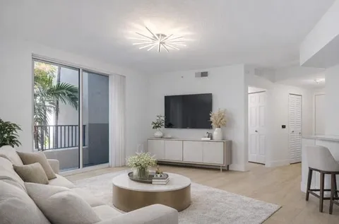 a kitchen with a sink and chairs
