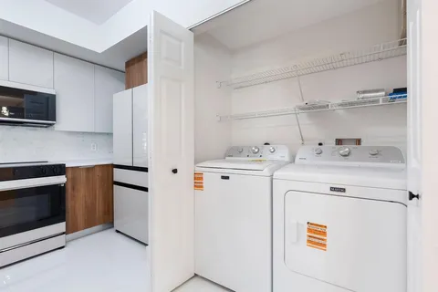 a kitchen with stainless steel appliances white cabinets and a refrigerator