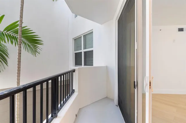 a view of balcony and small yard