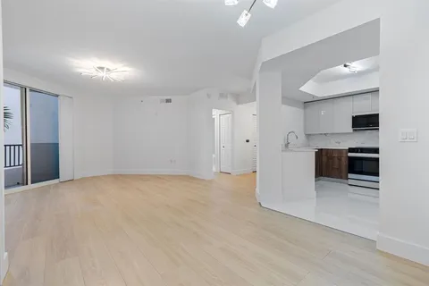 a view of a kitchen with a sink and a large window