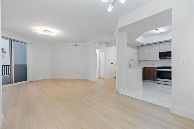 a view of a kitchen with a sink and a large window