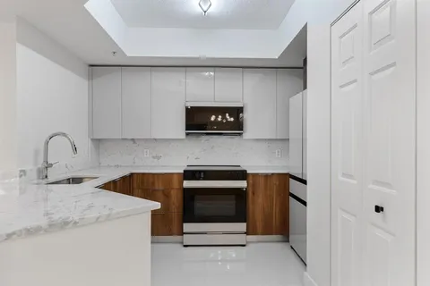 a kitchen with a sink and a stove top oven