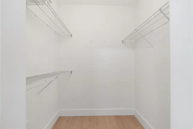 a kitchen with stainless steel appliances white cabinets and a refrigerator