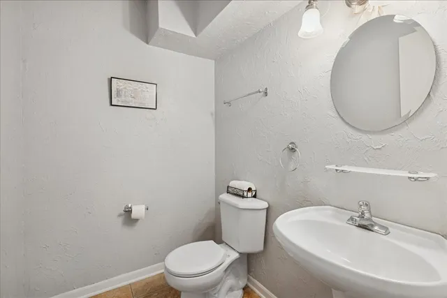 a white toilet sitting next to a bathroom sink