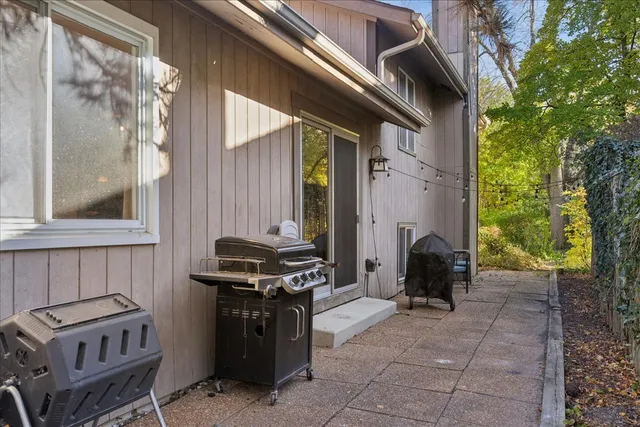 a view of a patio with a table and chairs
