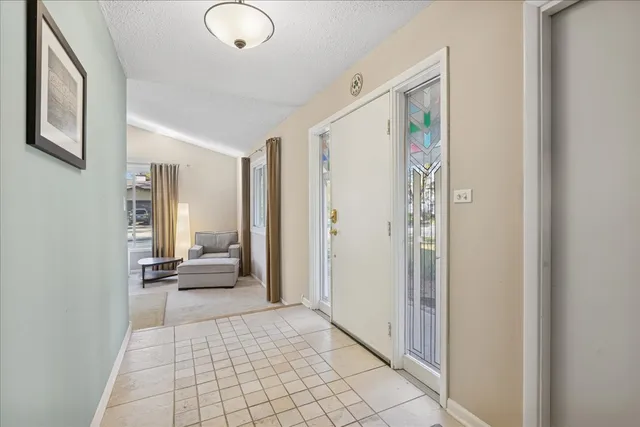 a view of a hallway with living room and dining room
