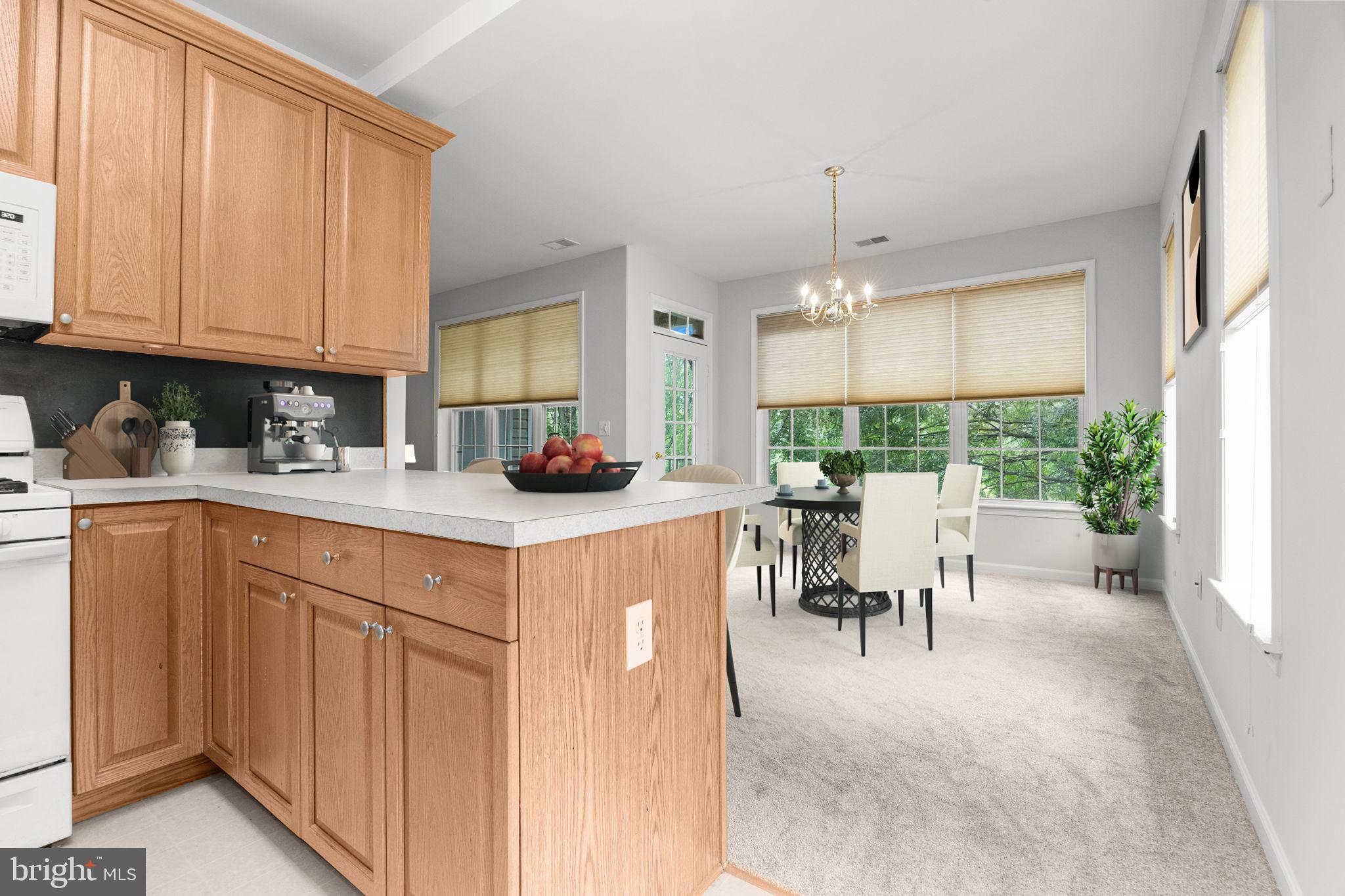 97 Kyle Way Ewing, NJ 08628 - Photo 11 of 33 a kitchen with kitchen island granite countertop a table chairs a sink and cabinets