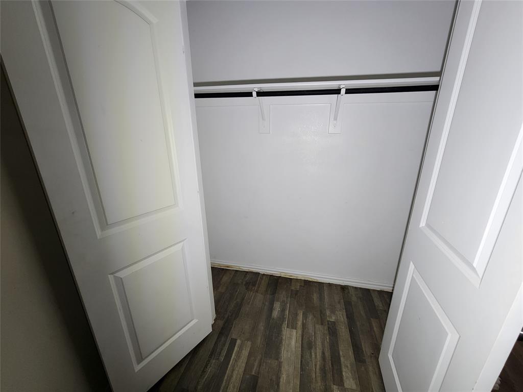 4229 Spring Avenue Dallas, TX 75210 - Photo 18 of 22 a view of walk in closet with wooden floor