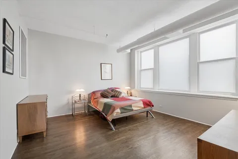 a bedroom with a bed and window